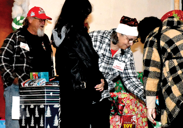 20221228 Landmarks Peggy handing toys web